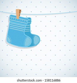 Baby boy shower card. Knitted socks on light background. Arrival card with place for your text.