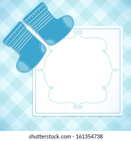 Baby boy shower card. Knitted socks on light background. Arrival card with place for your text.