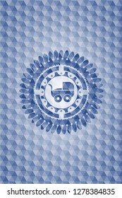 baby cart icon inside blue badge with geometric pattern.