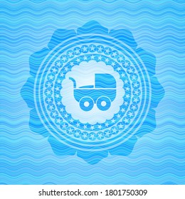 baby cart icon inside light blue water wave badge. 