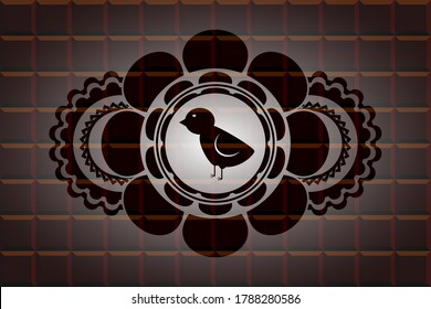 baby chicken icon inside chocolate emblem. Brown chic background. Illustration. 