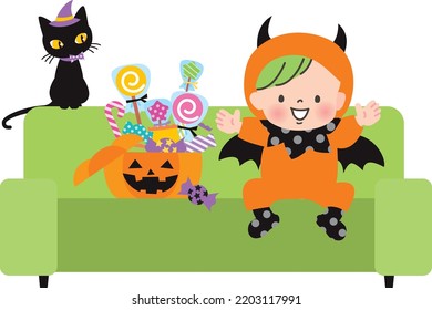 A baby child dressed as a devil and a lot of sweets
