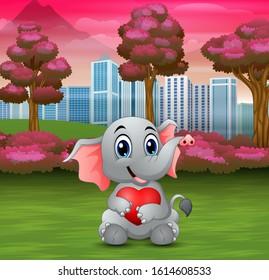 Baby elephant holding a red heart