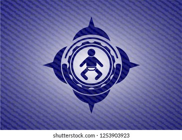 baby icon inside badge with denim background