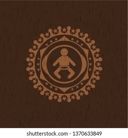 baby icon inside badge with wood background