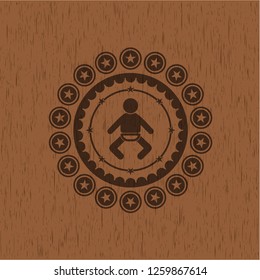 baby icon inside badge with wooden background