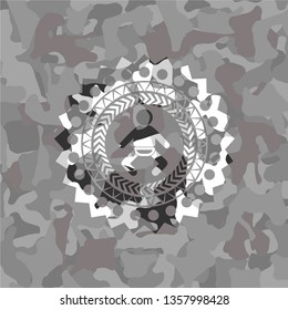 baby icon inside grey camouflaged emblem