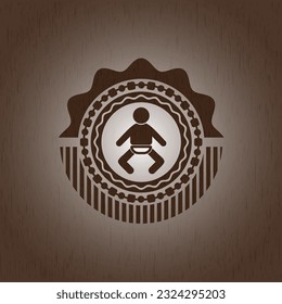 baby icon inside wood badge or emblem. 