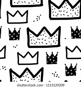 Baby seamless pattern with crowns and dots painted with a brush. Cute baby and little princess design. Children's room wallpaper and clothes texture. Scandinavian style. Black and white.