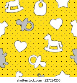 Baby seamless pattern. Gray, yellow, white colors. Illustrations of rocking horse, pacifier, baby clothes, teddy bear, bib, star, heart on polka dot background. 