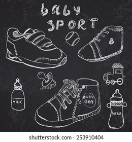 Baby shoes set sketch hand drawn on blackboard.