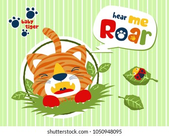 Baby tiger cartoon roaring in bush with ladybird on leaf. Vector cartoon illustration