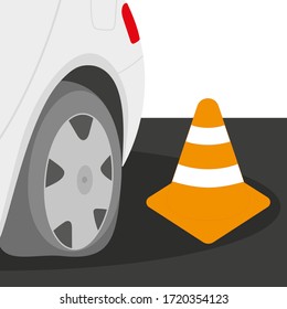 
The back of the car with a flat tire and a cone on the road