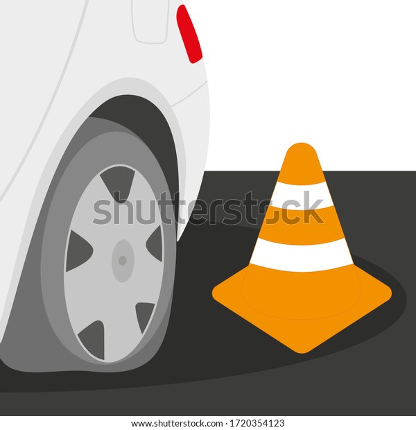 \
The back of the car with a flat tire and a cone on\
the road