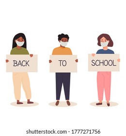 Back to school after pandemia concept. Diversity of children schoolboys and schoolgirls of different ethnicities standing together holding placard. Trendy teenagers wearing face mask with banners