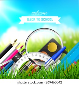 Back To School background with school supplies in front of blurred background