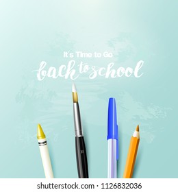 Back to school background with writing accessories on cyan background.