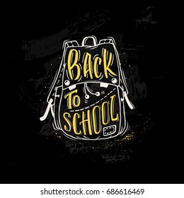 Back to school. School bag with hand-drawn lettering of yellow color and ink splashes on black background. Imitation of chalk drawing on the blackboard. Vector poster.