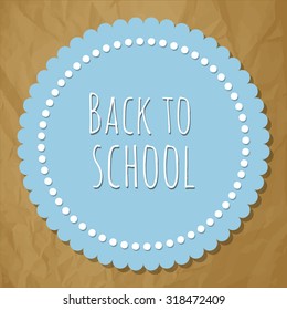 Back to school blue round label with dots on a crumpled paper brown background.