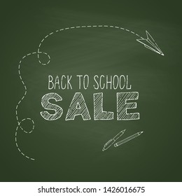 Back to school card. Back to school sale phrase. Green chalkboard background.