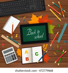 Back To School  Classroom Table - Tablet, Keyboard, Calculator, Autumn Leaves And School Supplies On Wooden Background - Top View. 