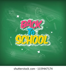 Back to School. Colorful word and school items and elements chalk drawing on blackboard.
