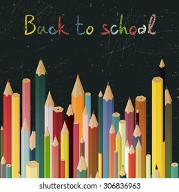 Back to school concept background with colored pencils on a blackboard