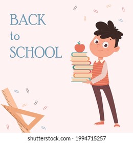 De vuelta al concepto escolar. Alegre escolar sosteniendo libros