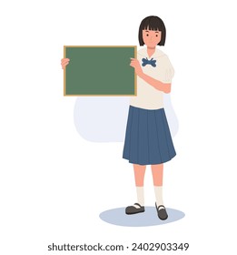 Back to School Concept. Thai Student Holding Small Blank Blackboard for Education.