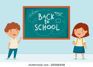 Back to school. Cute kids at the school board and the inscription.