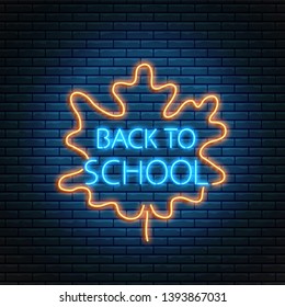 Back to school glowing neon sign with autumn leaf. Education return bright symbol. Back to school sale banner design.