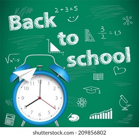 Back to school, green school background with alarm clock