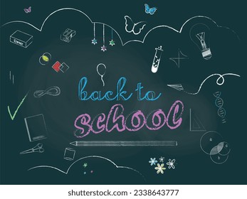 Back to school. Green chalkboard with text and school themed drawings painted with white and colored chalk.