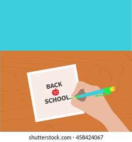 Back to school greeting card. Hand writing drawing pen. Girl holding pencil. Paper sheet. Wooden desk table. Body part. Template empty. Flat design. Isolated Blue background. Vector illustration