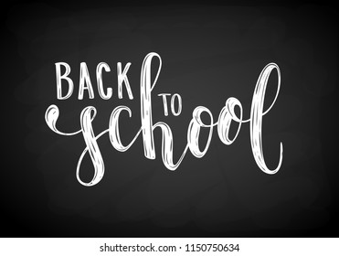 Back to school. Hand drawn brush pen lettering on black chalkboard. design for holiday greeting card and invitation, flyers, posters, banner
