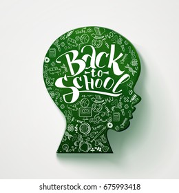 Back to school hand drawn typography on head for chalkboard. Vector illustration. Kids face profile contour chalkboard with many doodle icons on the contour of schoolboy profile. Back to school board