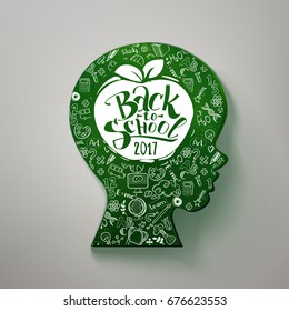 Back to school hand drawn typography on head for chalkboard. Vector illustration. Kids face profile contour chalkboard with many doodle icons and apple with back to school 2017 on the profile