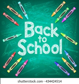 Back to School and School Items on Green Chalkboard Background with Different Colored Crayons
