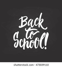 Back to school - lettering calligraphy phrase, handwritten text isolated on the black chalkboard background. Fun typography greeting and invitation card or t-shirt print design.