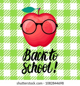 Back to school lettering and illustration. Vector Character red Apple with glasses smiling isolated on green cell background.