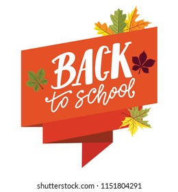Back to school lettering on orange ribbon banner with autumn leaves around.