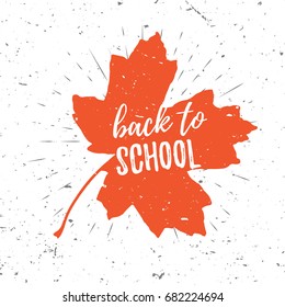 Back to school lettering typography on red maple leaf with burst on a old textured background. Hand drawn trendy design for a logo, greeting cards, invitations, posters, prints, banners, t-shirts