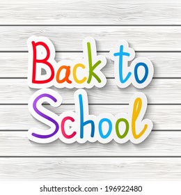Back to school message on wooden background