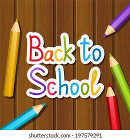 Back to school message on wooden background