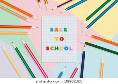Back to school. School notebook and pencils, on a multicolored background. Education concept.