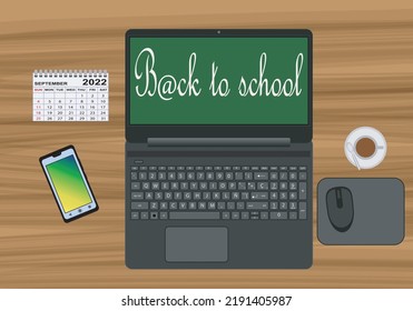 
Back To School Online Written On Laptop Screen, Notebook, Mobile Phone, Calendar, Wireless Mouse, Mouse Pad And Cup Of Cocoa With Teaspoon On Wooden Table