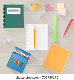 Back to school. A set of stationery with a long shadow. Wooden desktop top view. Teacher Day.
