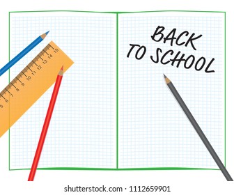 Back to school sign on math notebook, color pencils and orange ruler