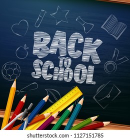 Back to School with school supplies and doodles on chalkboard background
