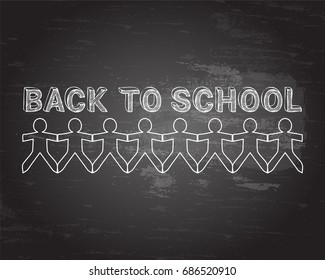 Back to school text hand drawn with paper people on blackboard background

